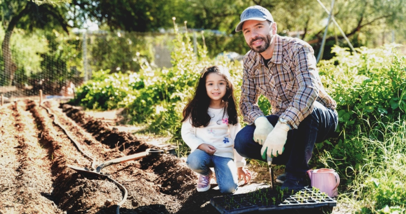 Image of father and daughter kneeling for a photo